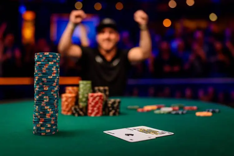 Poker table scene with chips and casually placed cards, evoking the aftermath of a Michael Mizrachi tournament win.